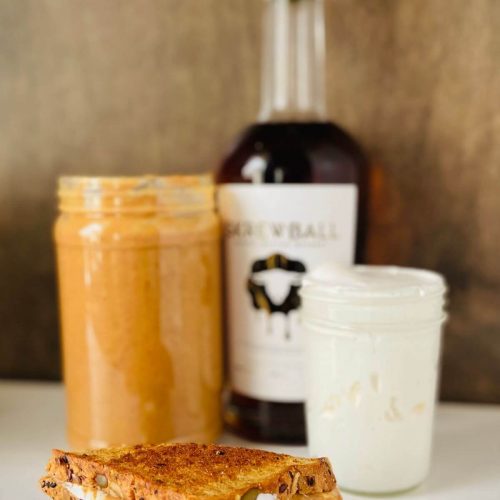 Grilled fluffernutter sandwich with a jar of peanut butter, marshmallow fluff, and peanut butter whiskey