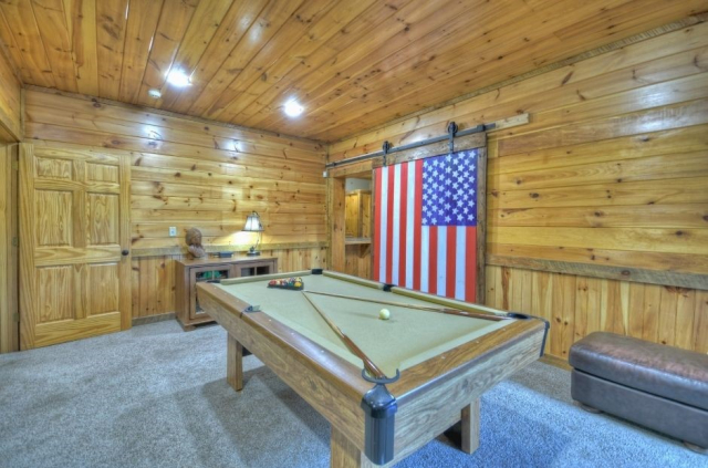 Choctaw Mtn Lodge basement pool table and American flag barn door