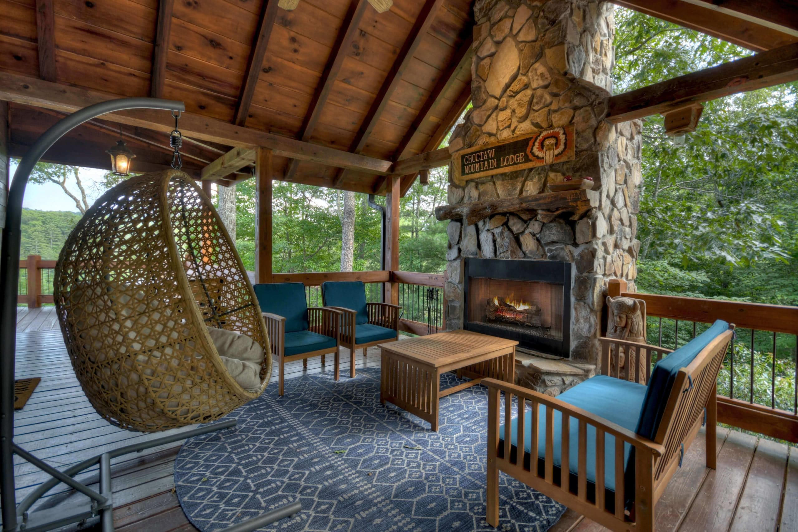 Choctaw Mtn Lodge outdoor fireplace with seating area and egg chair