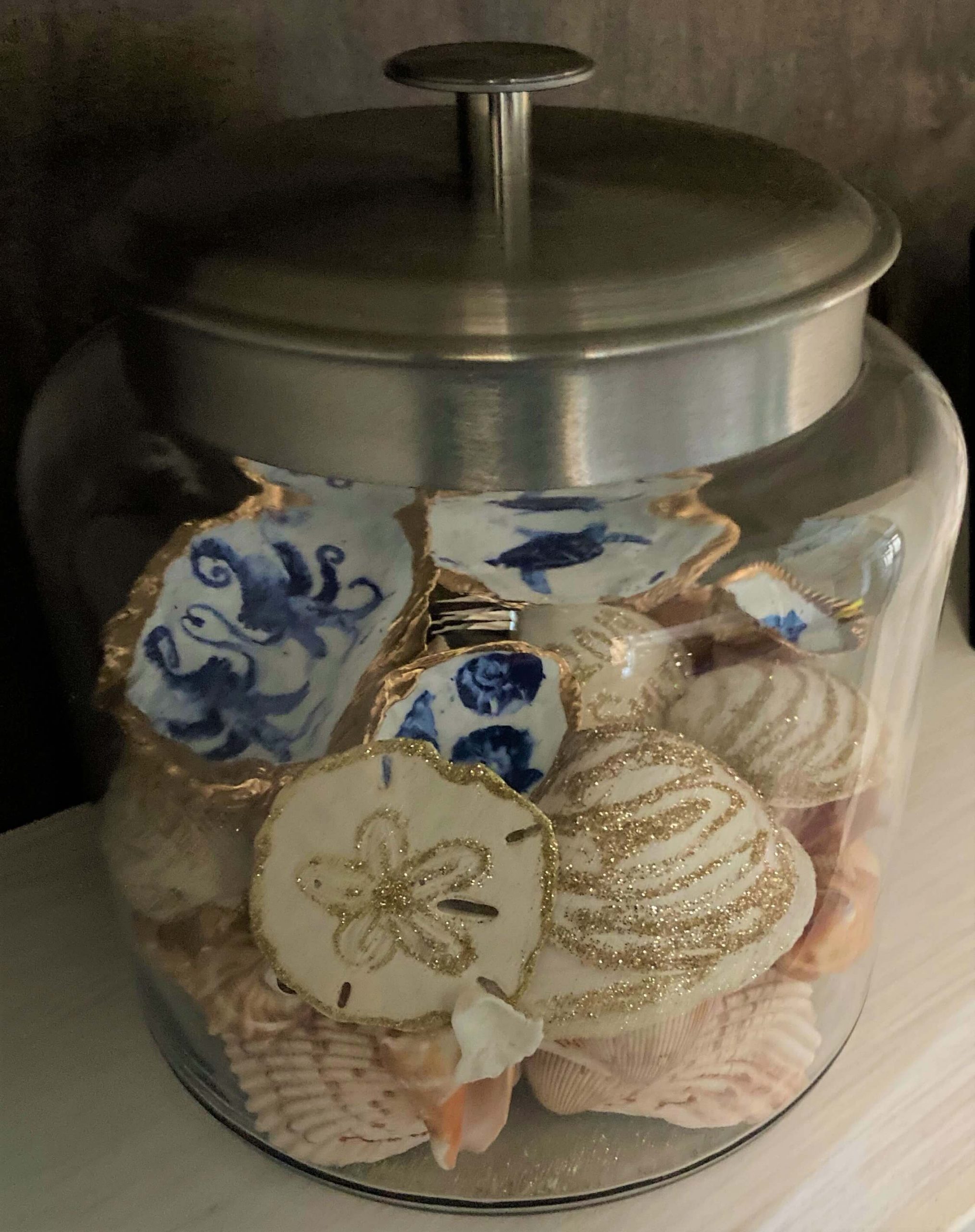 Decoupage and glittered sea shells displayed in a jar