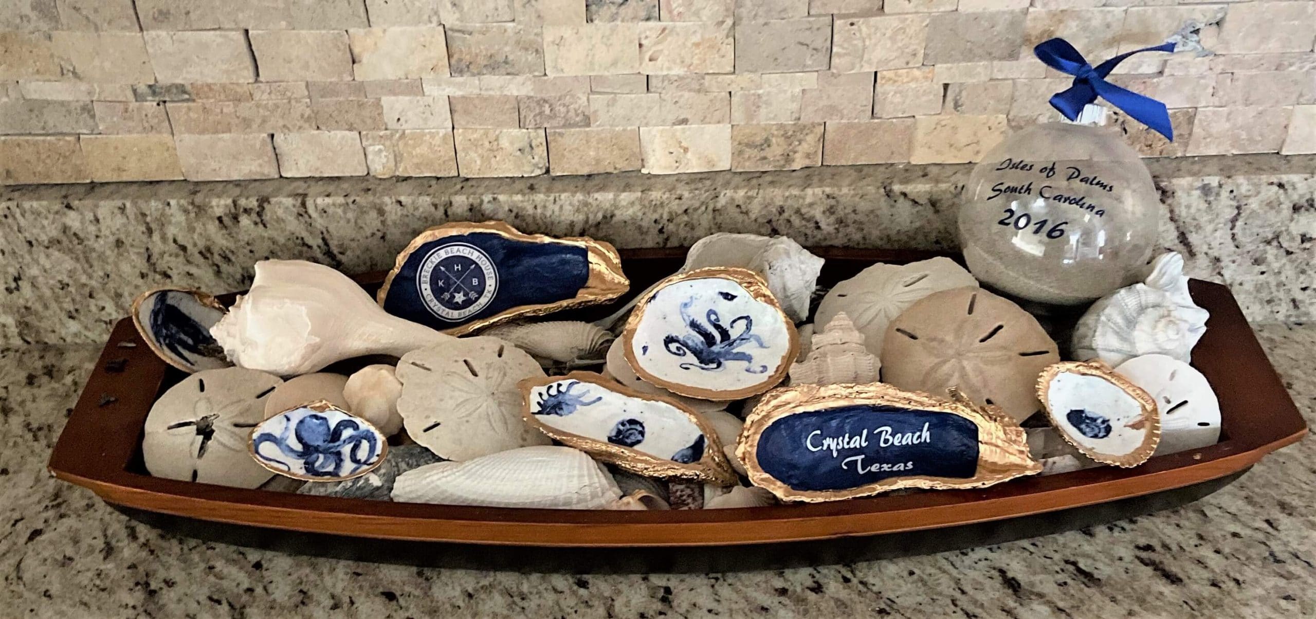 Decorated sea shells and natural sea shells displayed in a tray