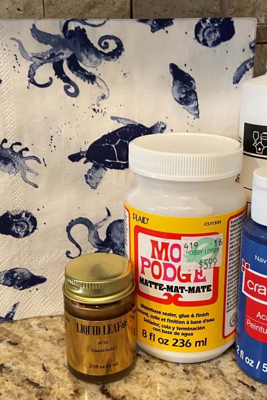 Supplies on the counter include liquid leaf, modge podge and various paints.